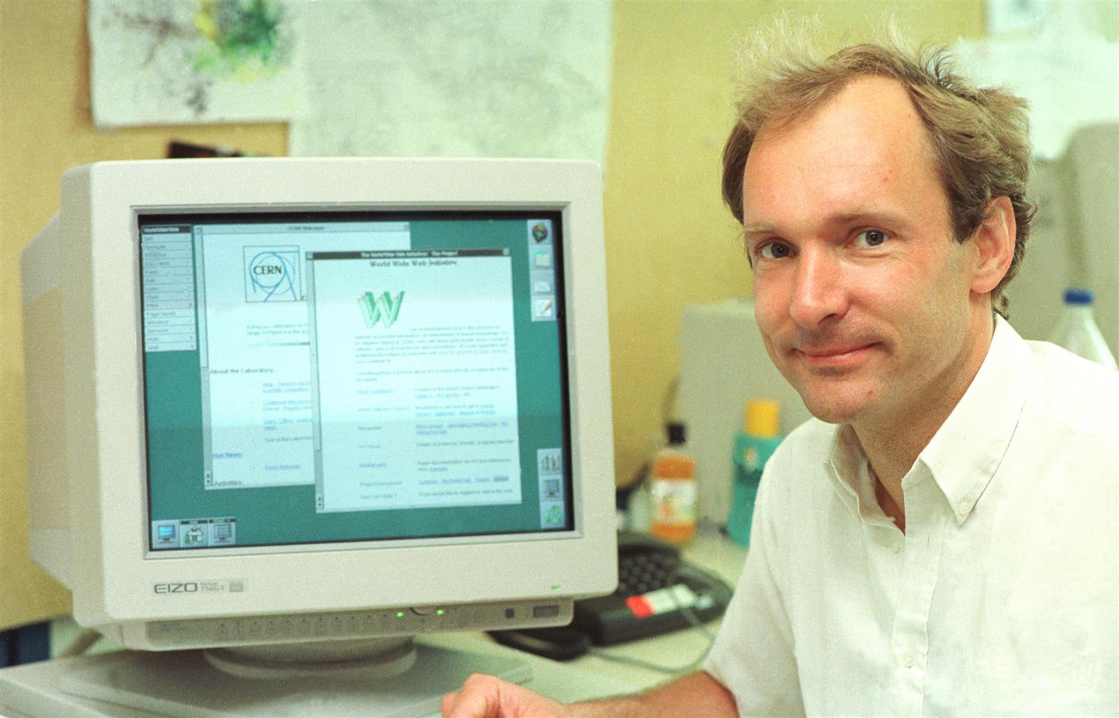 Photo of Tim Berners-Lee next to a computer